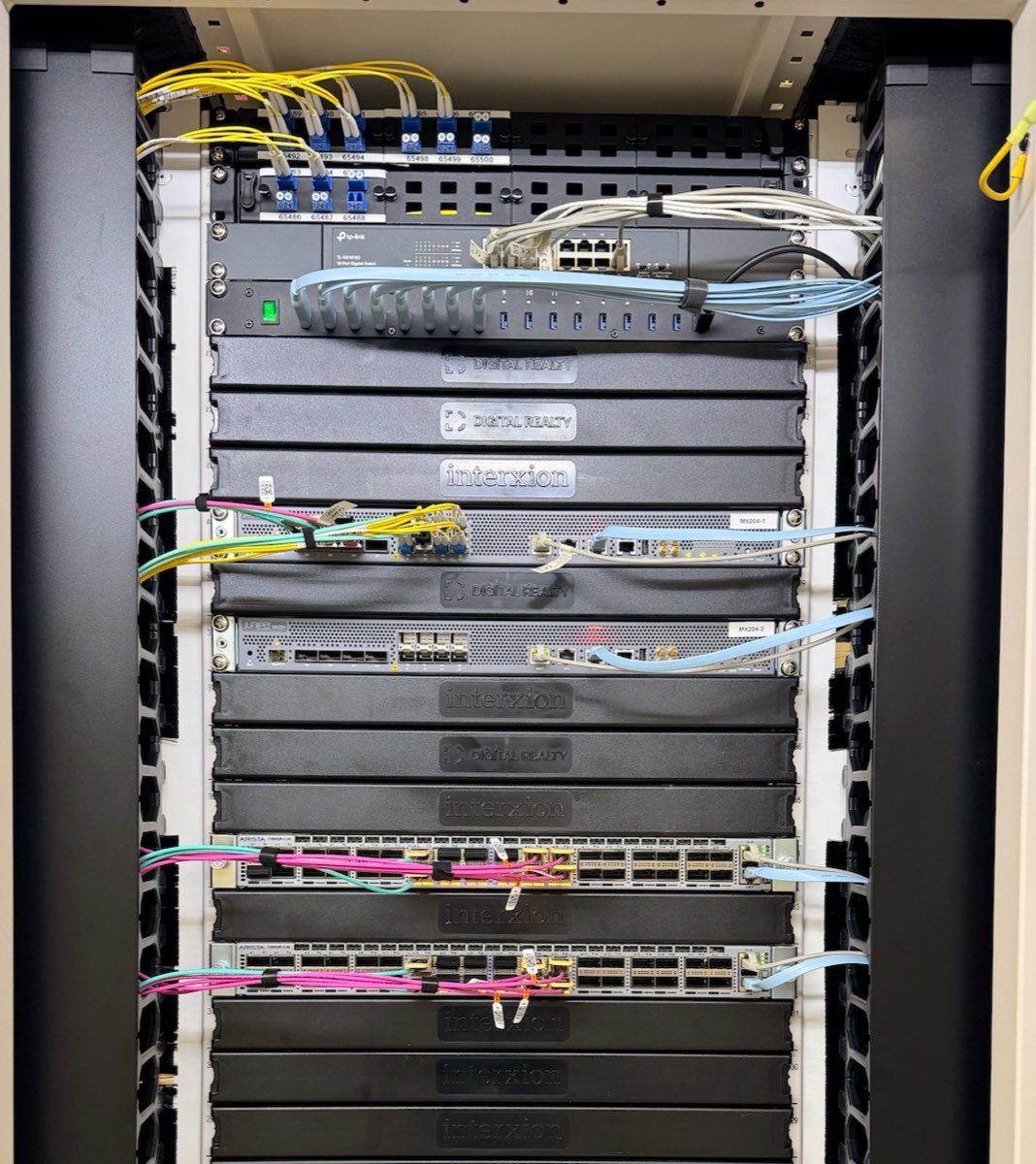 GINERNET core network rack with routers and switches wired with optical fibre